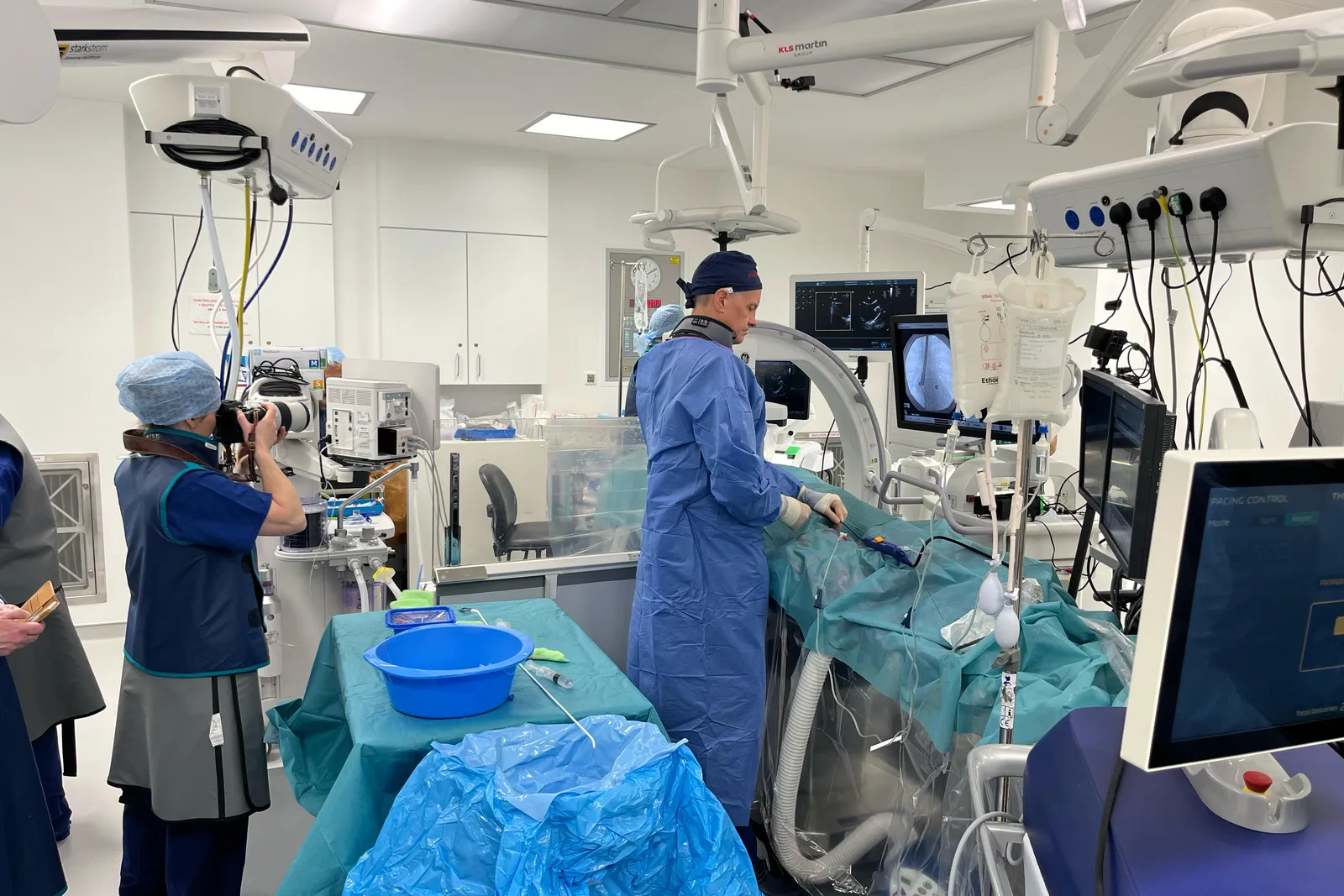 A crew member photographing a physician at work during an earlier Boston Scientific shoot.